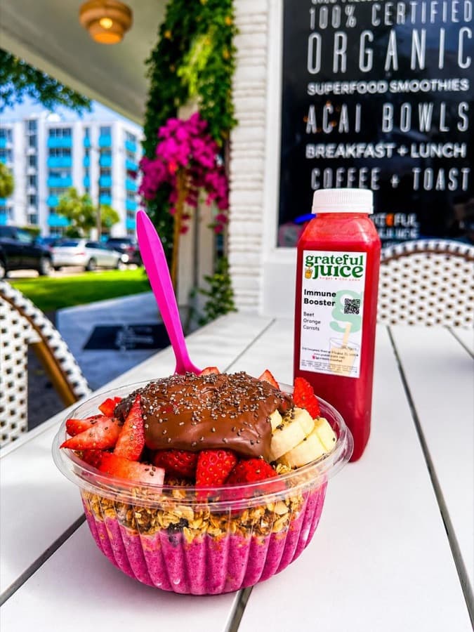 An açaí bowl and Immune Booster juice outside the shop