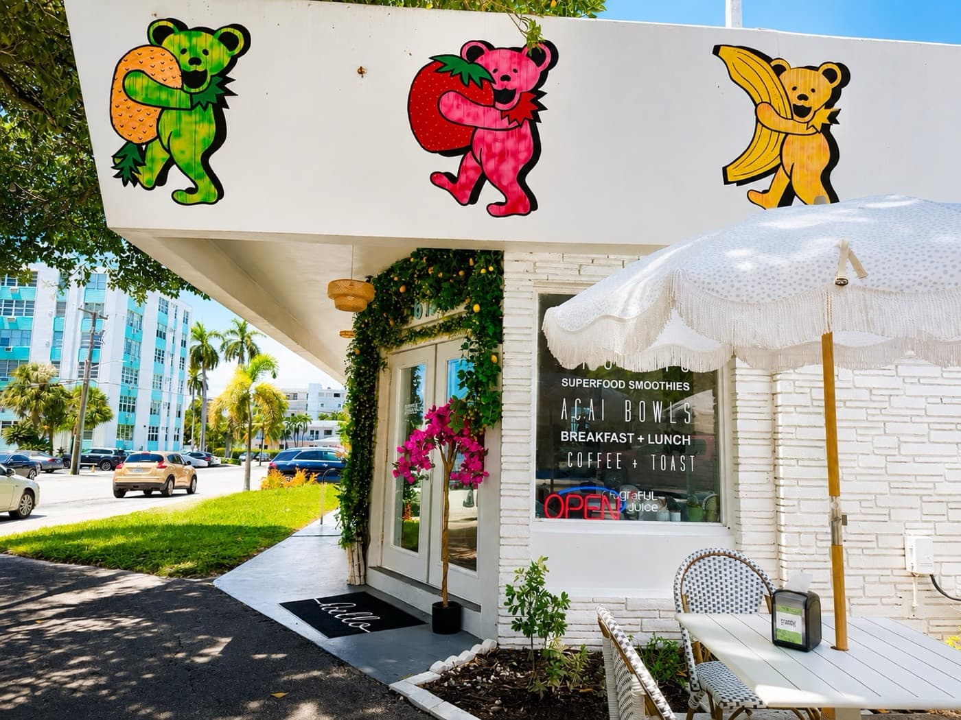 The front door and shaded patio table at Grateful Juice, a block from the beach